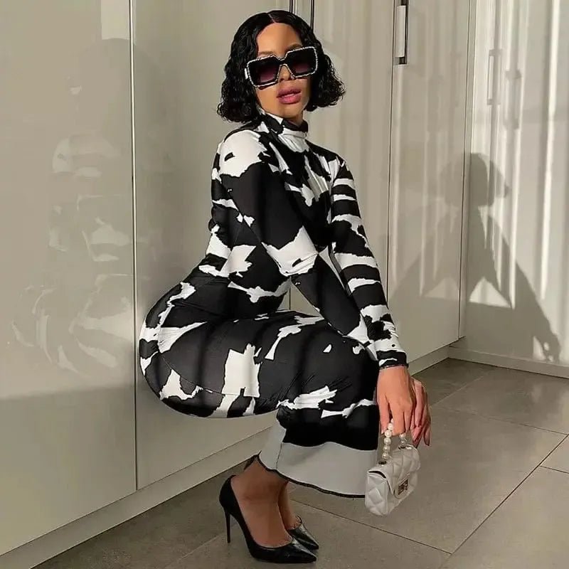 Black and white pattern polo neck slimming dress for women worn with black heels and sunglasses