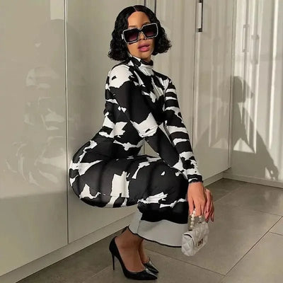 Black and white pattern polo neck slimming dress for women worn with black heels and sunglasses